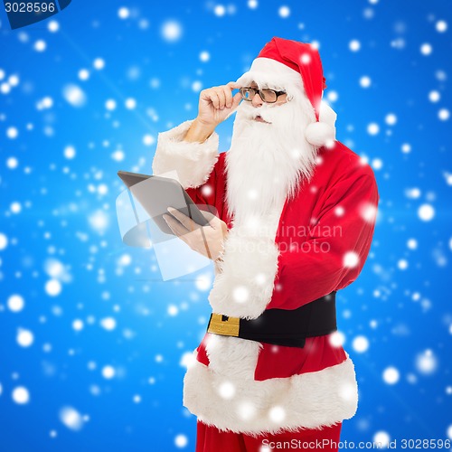 Image of man in costume of santa claus with tablet pc