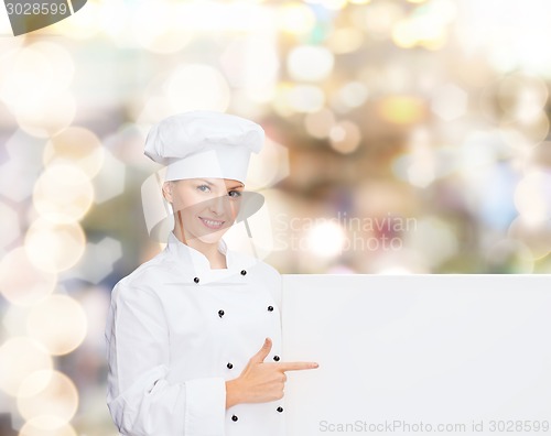 Image of smiling female chef with white blank board