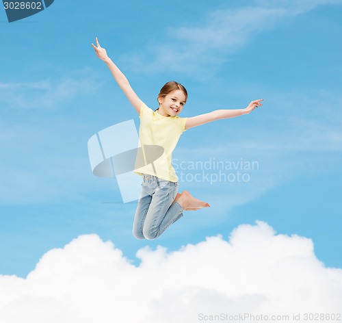 Image of smiling little girl jumping