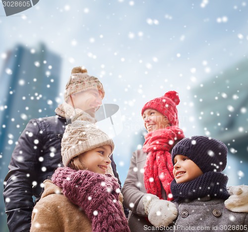 Image of happy family in winter clothes outdoors