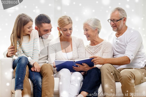 Image of happy family with book or photo album at home