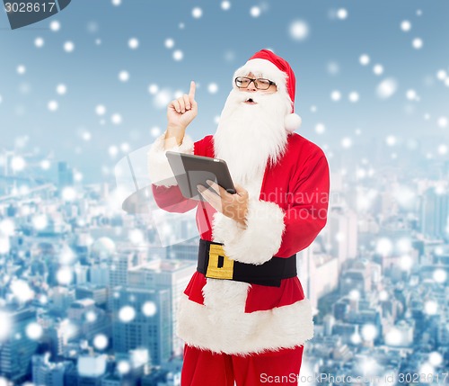 Image of man in costume of santa claus with tablet pc