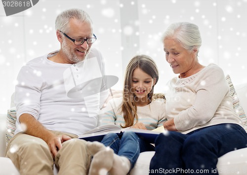 Image of smiling family with book at home