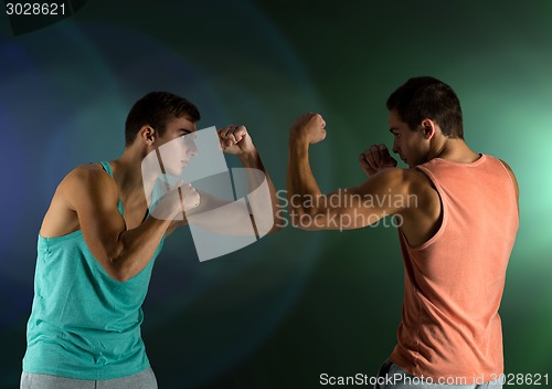 Image of young men fighting hand-to-hand