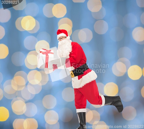 Image of man in costume of santa claus with gift box