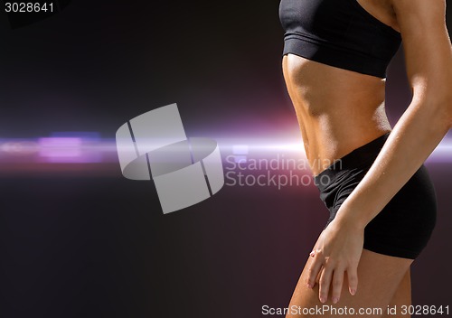 Image of close up of athletic female abs in sportswear