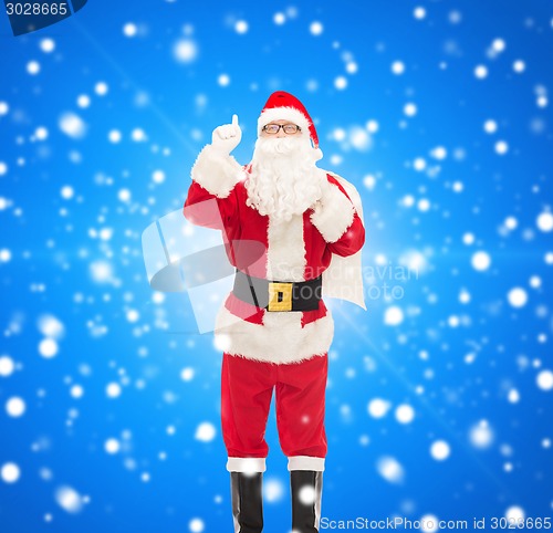 Image of man in costume of santa claus with bag