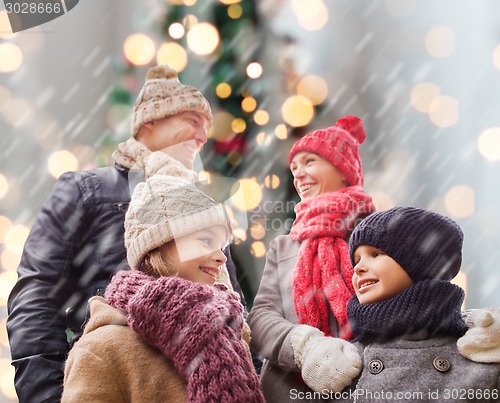 Image of happy family in winter clothes outdoors