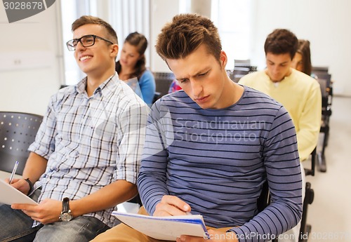 Image of group of smiling students in lecture hall