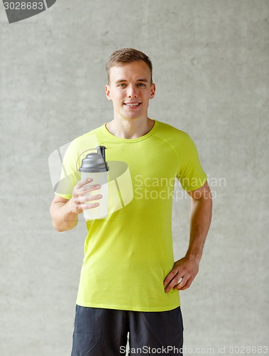 Image of smiling man with protein shake bottle