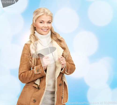 Image of smiling young woman in winter clothes