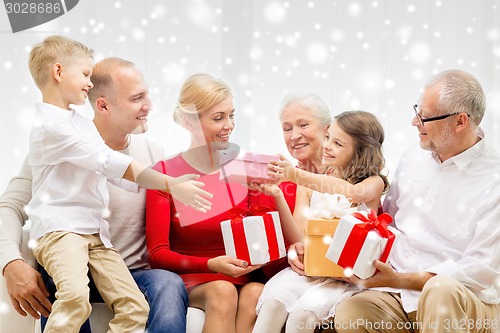 Image of smiling family with gifts at home