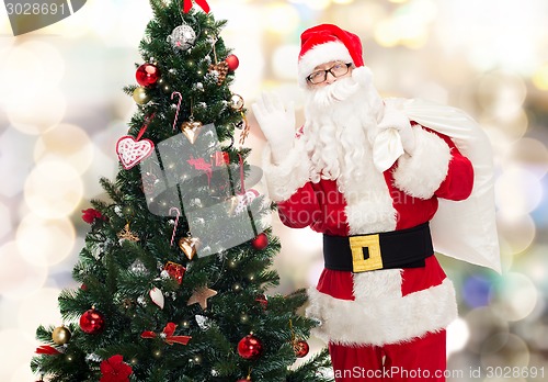 Image of santa claus with bag and christmas tree