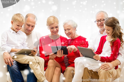 Image of smiling family with tablet pc computers at home