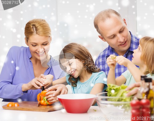 Image of happy family with two kids making dinner at home