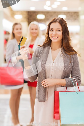 Image of women with shopping bags and credit card in mall