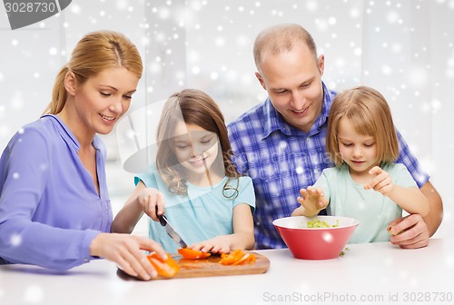 Image of happy family with two kids making dinner at home