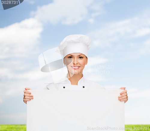 Image of smiling female chef with white blank board