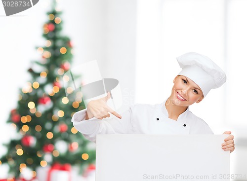 Image of smiling female chef with white blank board