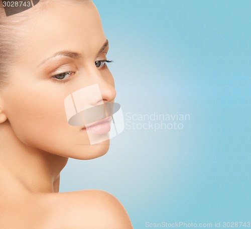 Image of beautiful young woman over blue background