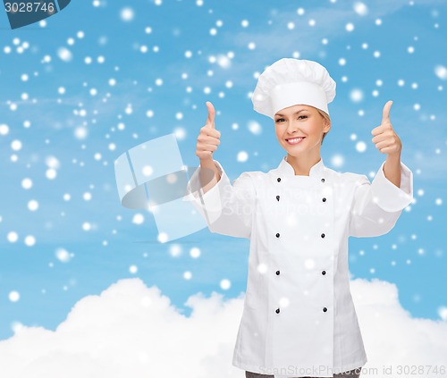 Image of smiling female chef showing thumps up