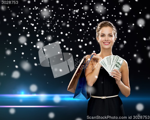 Image of smiling woman in dress with shopping bags