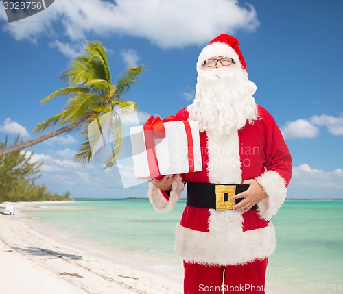 Image of man in costume of santa claus with gift box