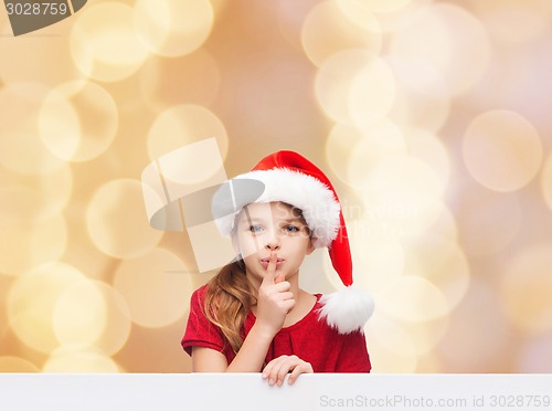 Image of smiling little girl in santa helper hat