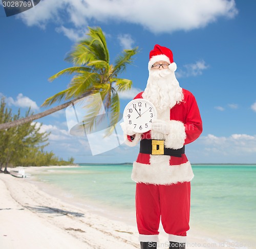 Image of man in costume of santa claus with clock