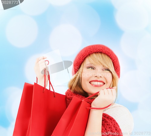 Image of smiling young woman with shopping bags