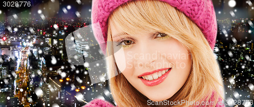 Image of close up of smiling young woman in winter clothes