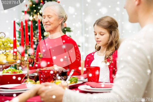 Image of smiling family having holiday dinner at home