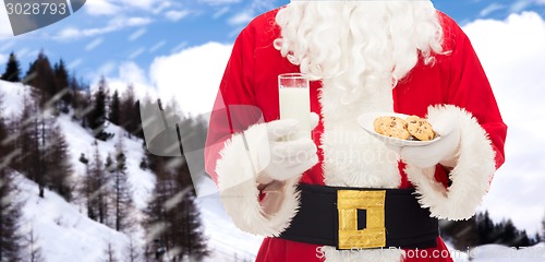 Image of close up of santa claus with milk and cookies