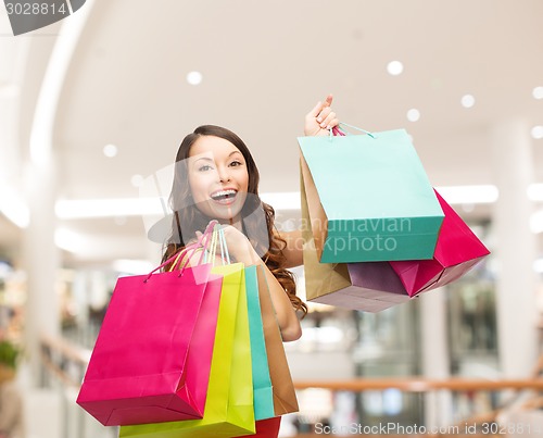 Image of smiling young woman with shopping bags