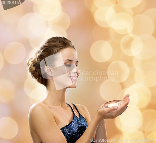 Image of smiling woman in evening dress with diamond