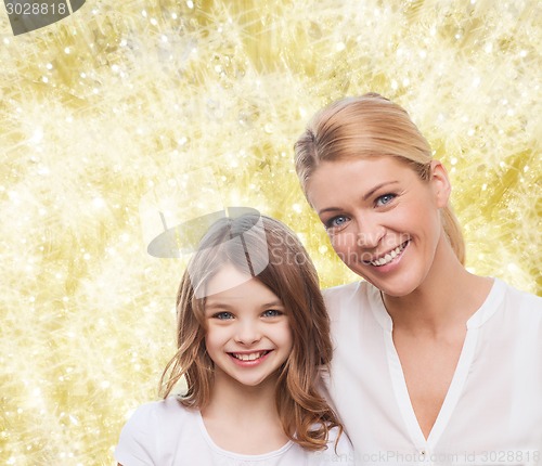Image of smiling mother and little girl