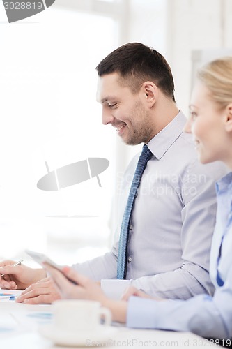 Image of smiling businessman working in office