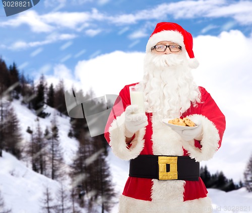 Image of santa claus with glass of milk and cookies