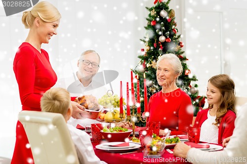 Image of smiling family having holiday dinner at home