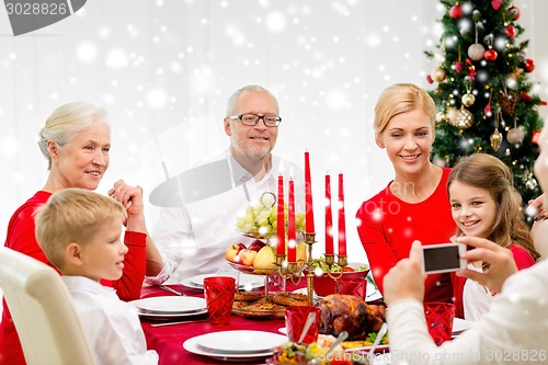 Image of smiling family having holiday dinner at home