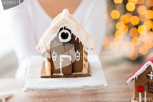 Image of close up of woman showing gingerbread house