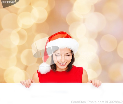 Image of woman in santa helper hat with blank white board