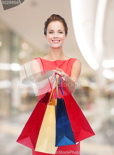 Image of smiling young woman with shopping bags