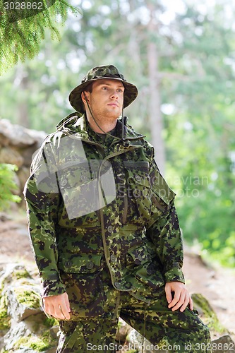 Image of young soldier or ranger in forest