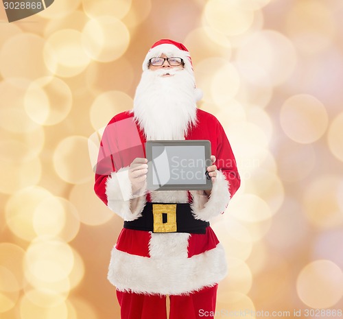 Image of man in costume of santa claus with tablet pc