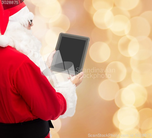 Image of man in costume of santa claus with tablet pc