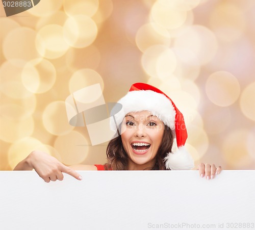 Image of woman in santa helper hat with blank white board