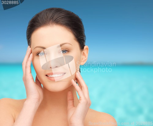 Image of beautiful young woman over blue sky and sea