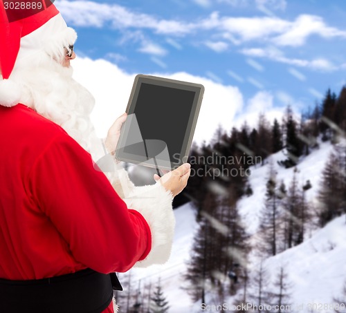 Image of man in costume of santa claus with tablet pc