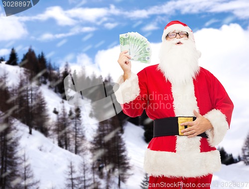 Image of man in costume of santa claus with euro money